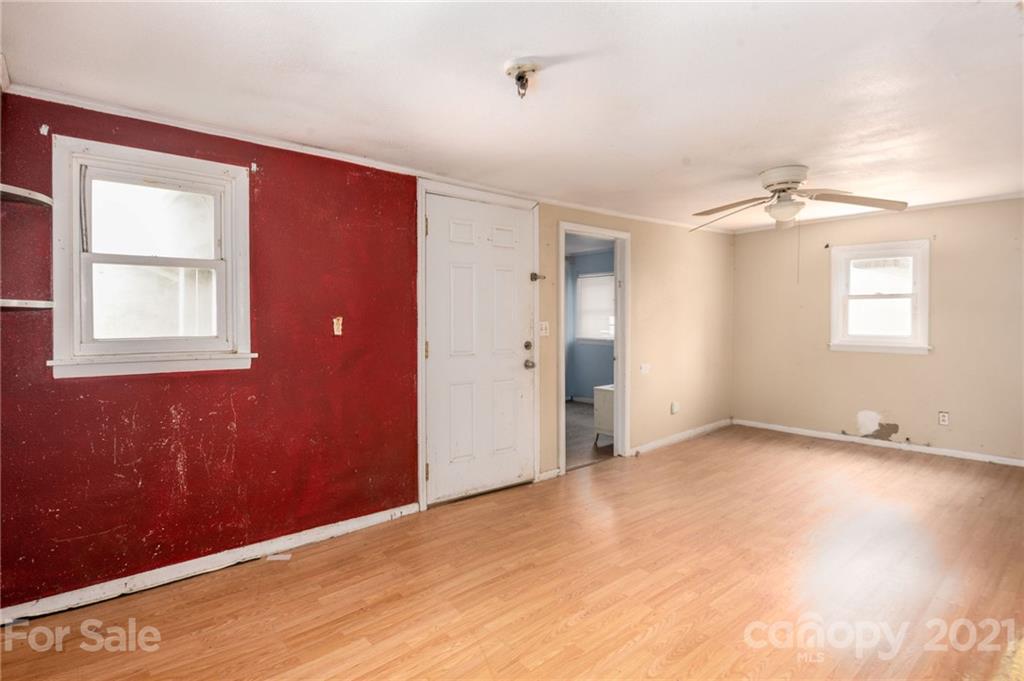 419 Incinerator Road Clyde, NC 28721 - Photo 4 of 17 an empty room with windows and closet