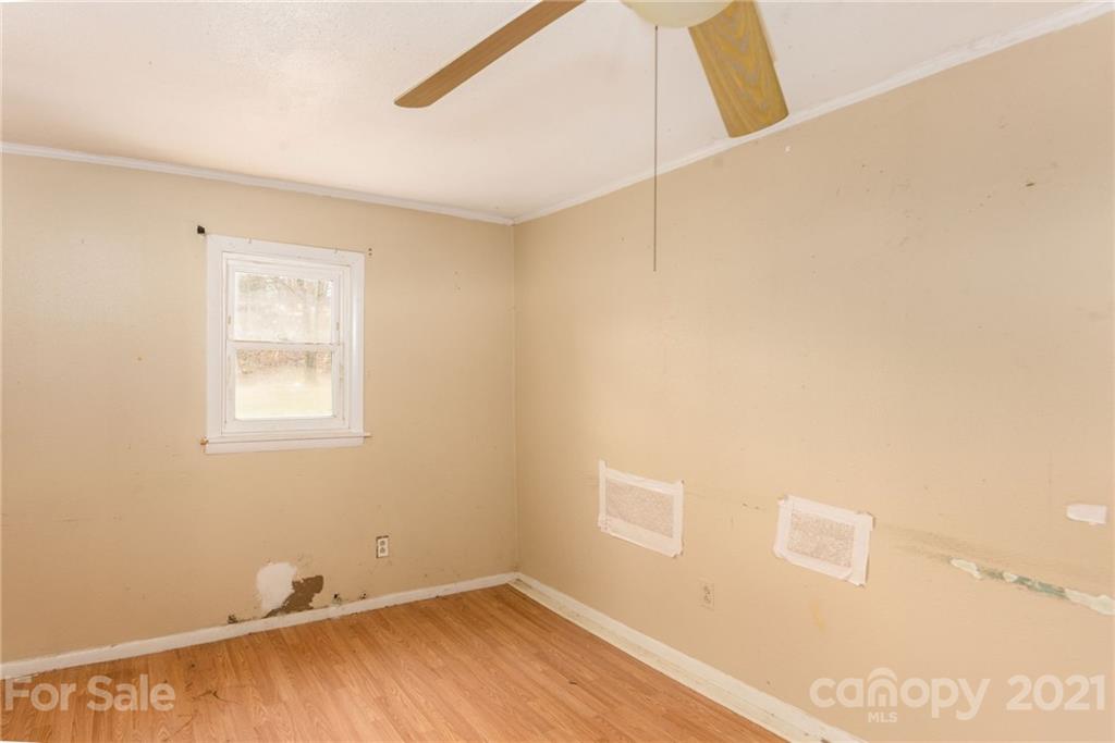 419 Incinerator Road Clyde, NC 28721 - Photo 6 of 17 a view of a small space with wooden floor and a window