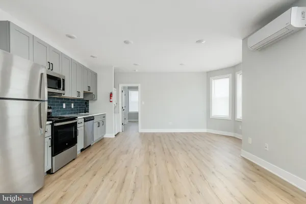 a kitchen with cabinets and white appliances