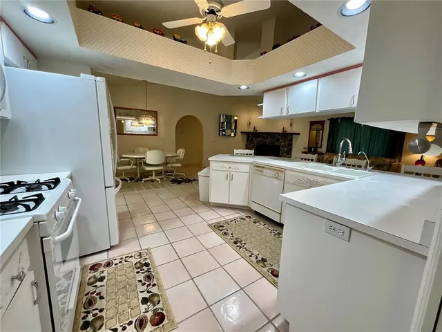 a kitchen with a sink a stove cabinets and a counter top space