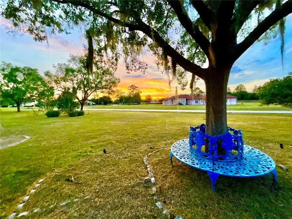 a view of a lake with a table and chairs under an umbrella