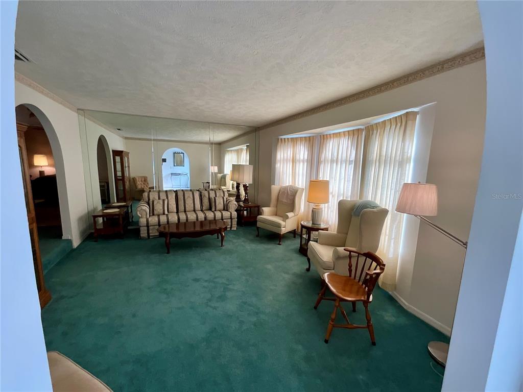 7205 Northeast 61st Ave Road Silver Springs, FL 34488 - Photo 21 of 64 a living room with furniture and a window