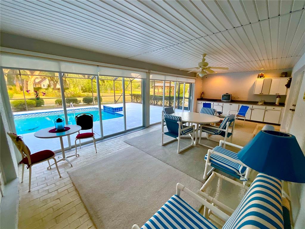 7205 Northeast 61st Ave Road Silver Springs, FL 34488 - Photo 24 of 64 a living room with furniture and a large window