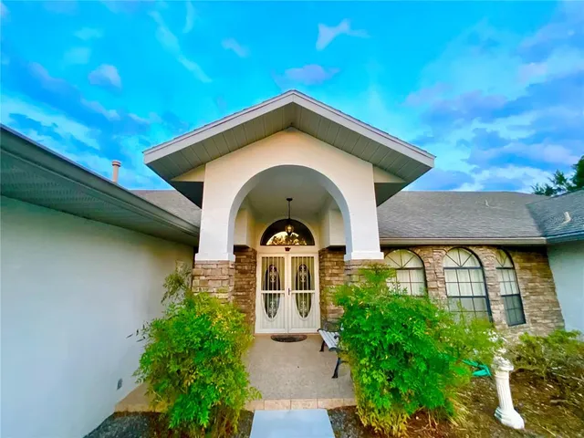 a view of swimming pool is middle in the garden