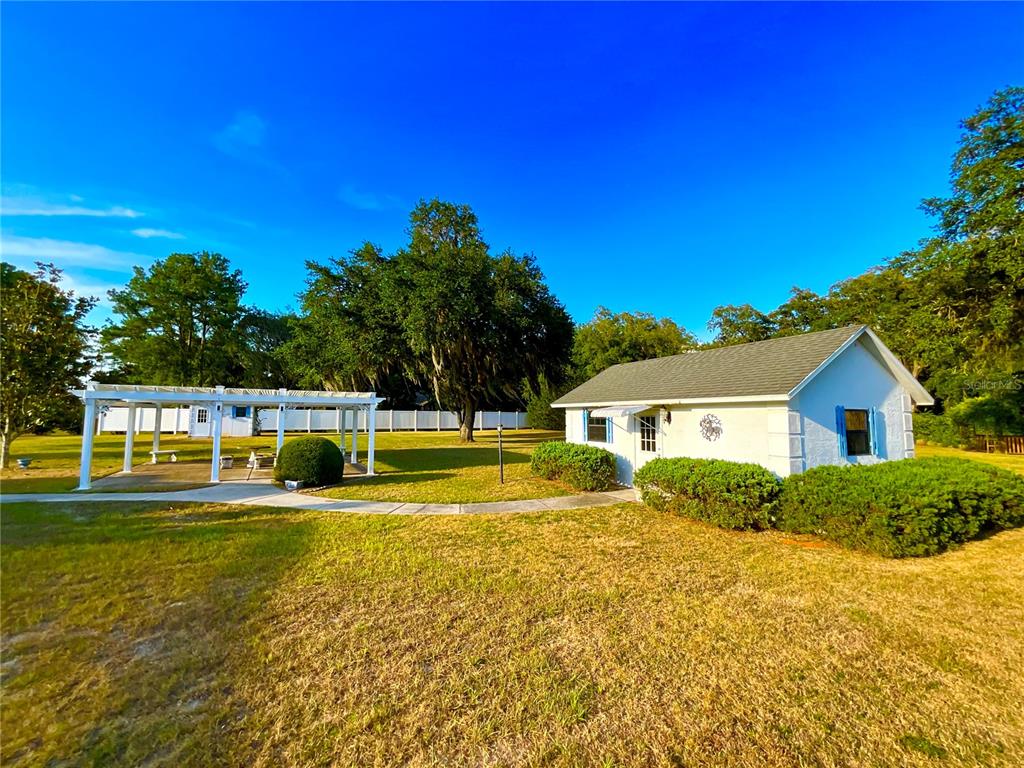 7205 Northeast 61st Ave Road Silver Springs, FL 34488 - Photo 29 of 64 a view of a house with a swimming pool