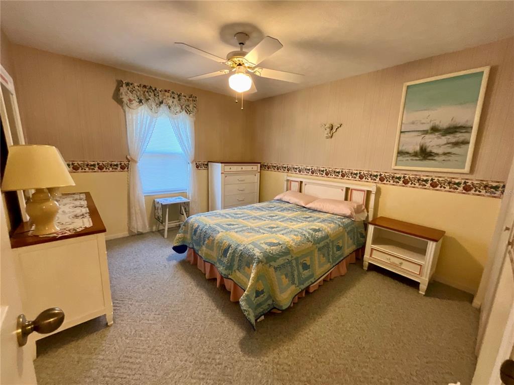 7205 Northeast 61st Ave Road Silver Springs, FL 34488 - Photo 35 of 64 a spacious bedroom with a bed and ceiling fan