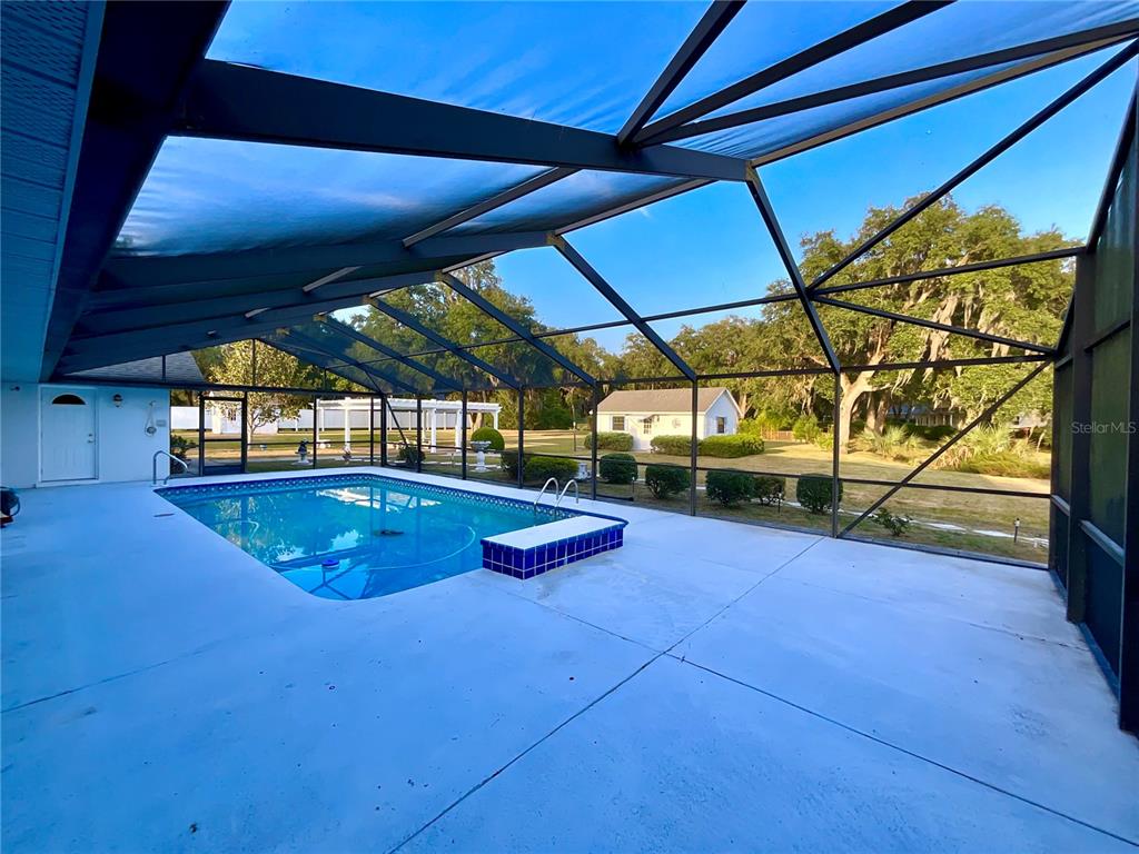 7205 Northeast 61st Ave Road Silver Springs, FL 34488 - Photo 36 of 64 a view of swimming pool with a backyard