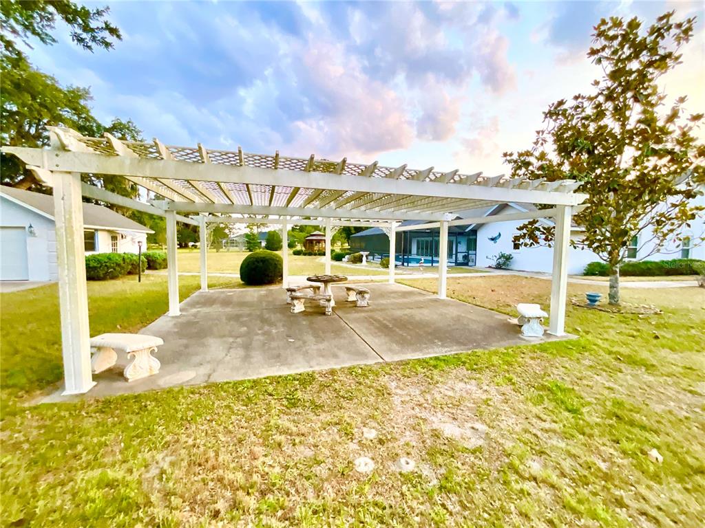 7205 Northeast 61st Ave Road Silver Springs, FL 34488 - Photo 39 of 64 a view of a swimming pool with an outdoor seating