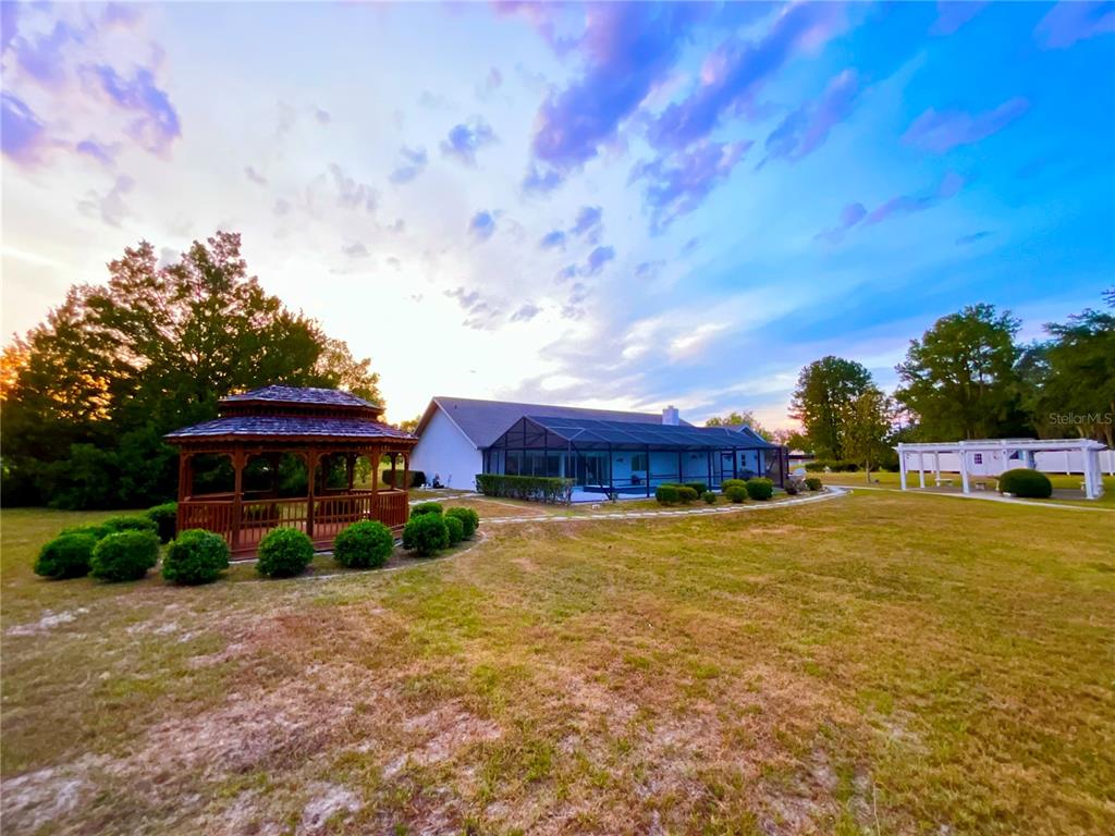 7205 Northeast 61st Ave Road Silver Springs, FL 34488 - Photo 41 of 64 a view of a house with a yard