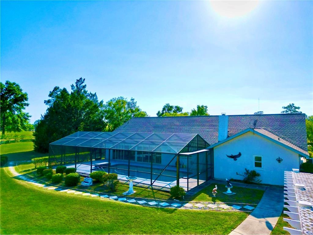 7205 Northeast 61st Ave Road Silver Springs, FL 34488 - Photo 43 of 64 a front view of a house with garden