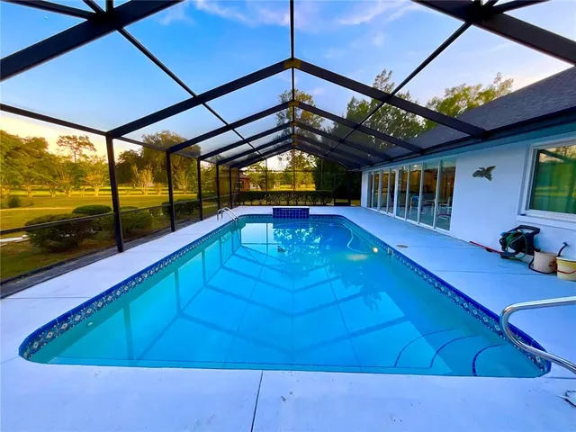 a view of swimming pool with seating space