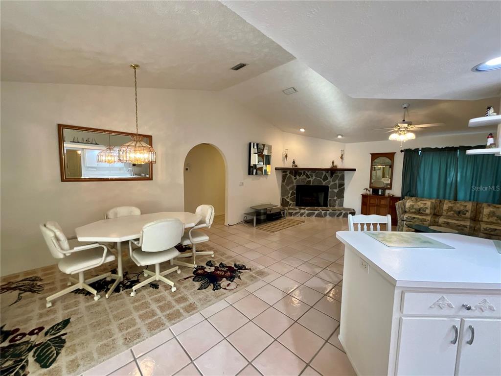 7205 Northeast 61st Ave Road Silver Springs, FL 34488 - Photo 8 of 64 a living room with furniture a dining table and kitchen view