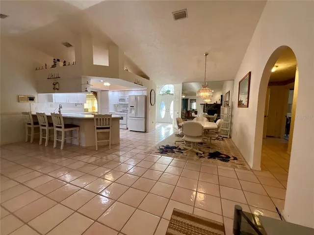 a kitchen with stainless steel appliances kitchen island granite countertop a sink and cabinets