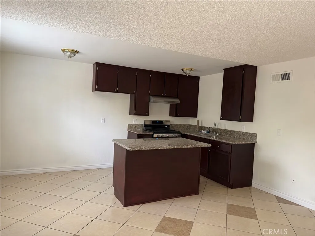 3791 Harvill Lane, Unit 4 Riverside, CA 92503 - Photo 3 of 10 a kitchen with stainless steel appliances granite countertop a sink and a stove