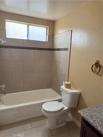 a bathroom with a toilet a sink and bathtub