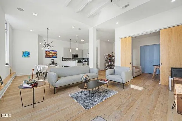 a living room with furniture and a wooden floor
