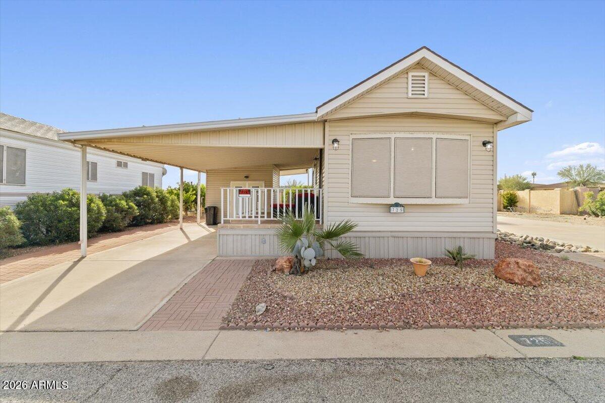 11201 North El Mirage Road, Unit 725 El Mirage, AZ 85335 - Photo 1 of 15 a front view of a house with garden