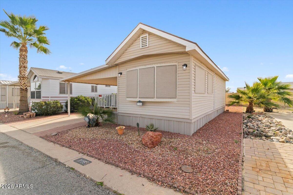 11201 North El Mirage Road, Unit 725 El Mirage, AZ 85335 - Photo 11 of 15 a front view of a house with garden