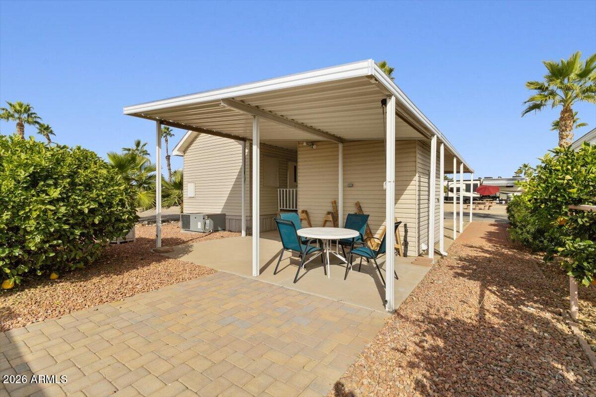 11201 North El Mirage Road, Unit 725 El Mirage, AZ 85335 - Photo 14 of 15 a view of a house with patio and a yard