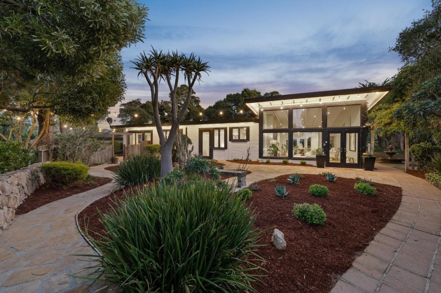 1030 Sombrero Road Pebble Beach, CA 93953 - Photo 1 of 1 a front view of a house with a garden