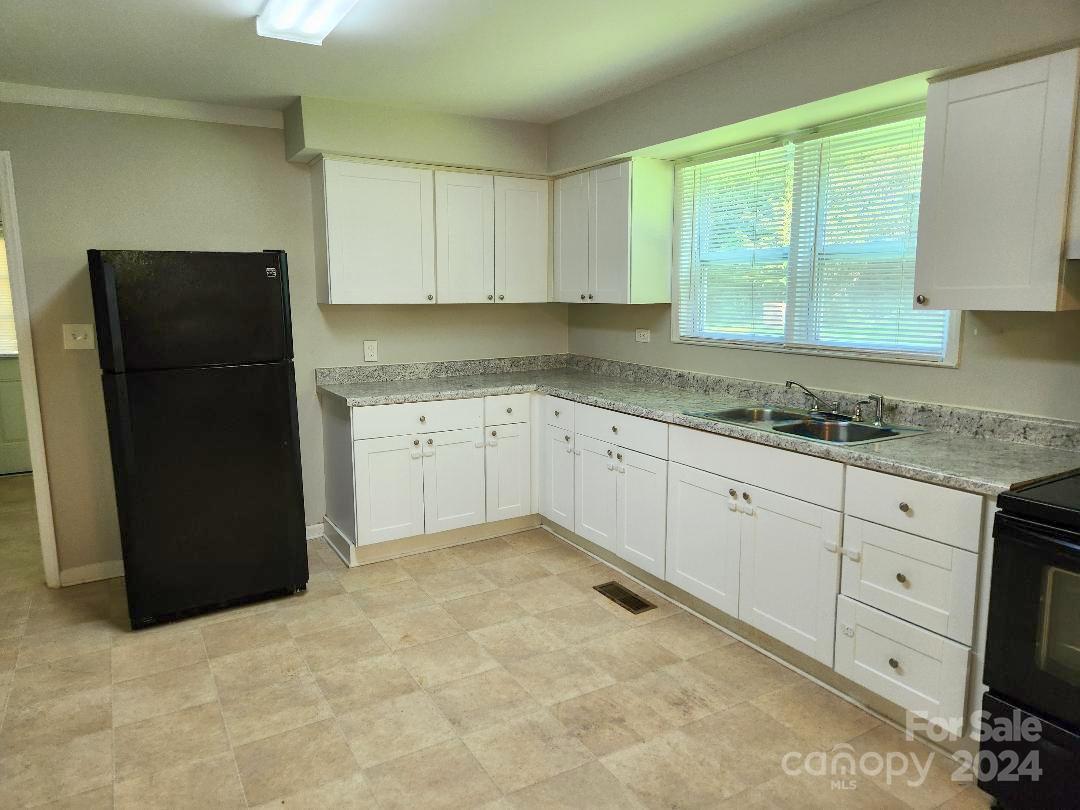 163 Hambright Road Clover, SC 29710 - Photo 4 of 12 a kitchen with a sink window and cabinets