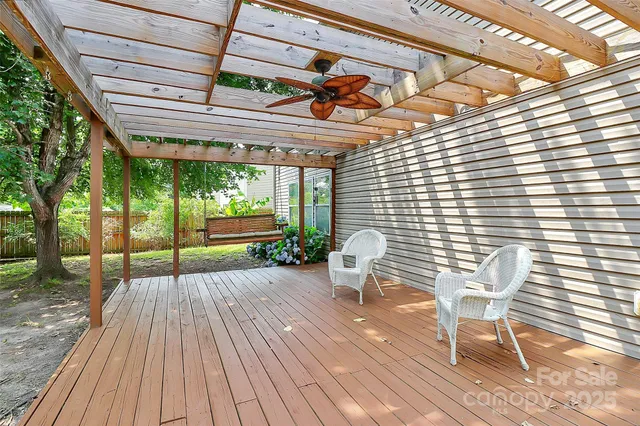 a porch with a table and chairs in front of it