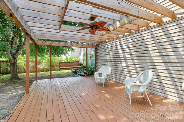 a porch with a table and chairs in front of it