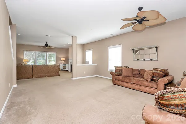 a living room with furniture and kitchen view