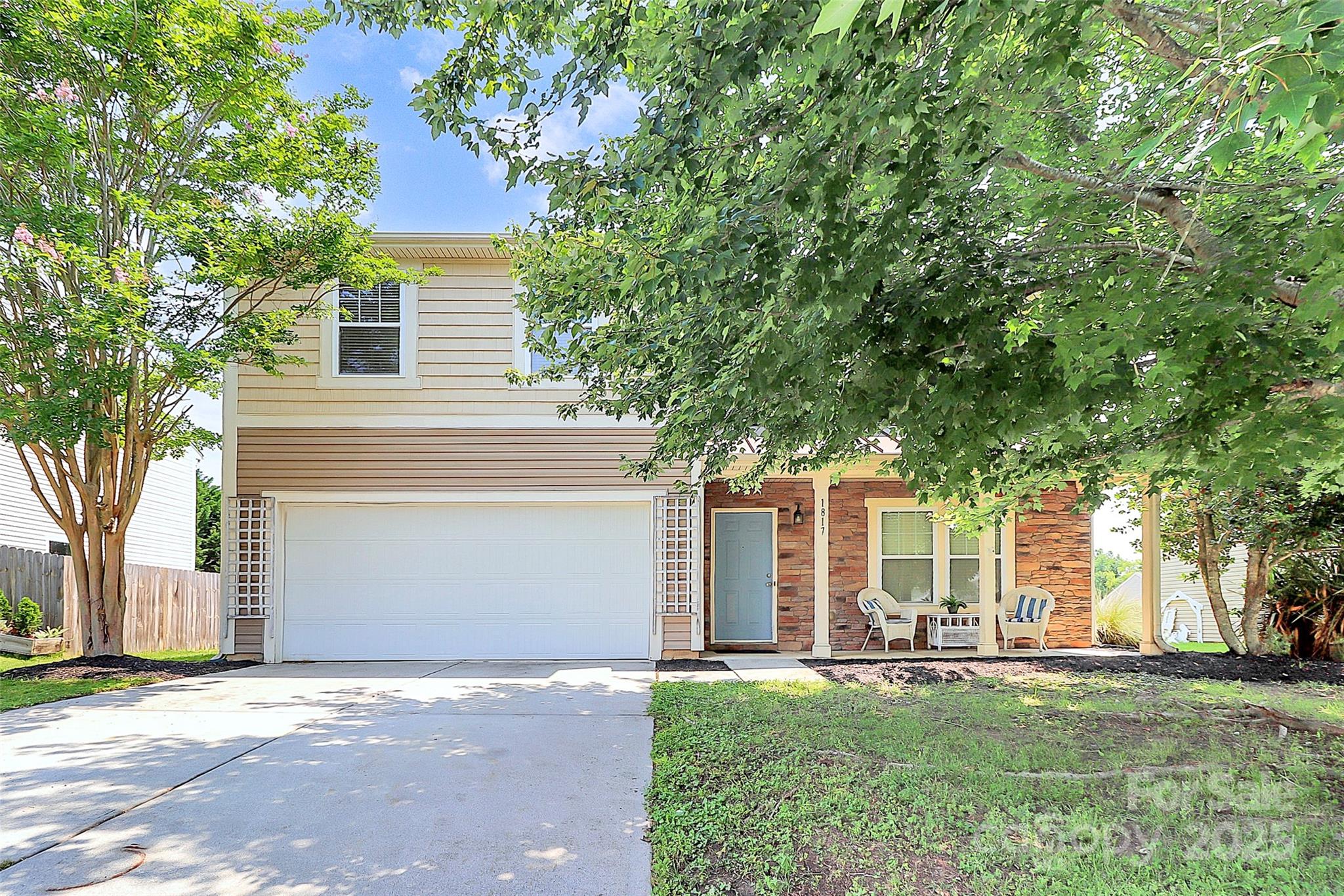 1817 Tradd Avenue Clover, SC 29710 - Photo 2 of 42 a front view of a house with a garden and trees