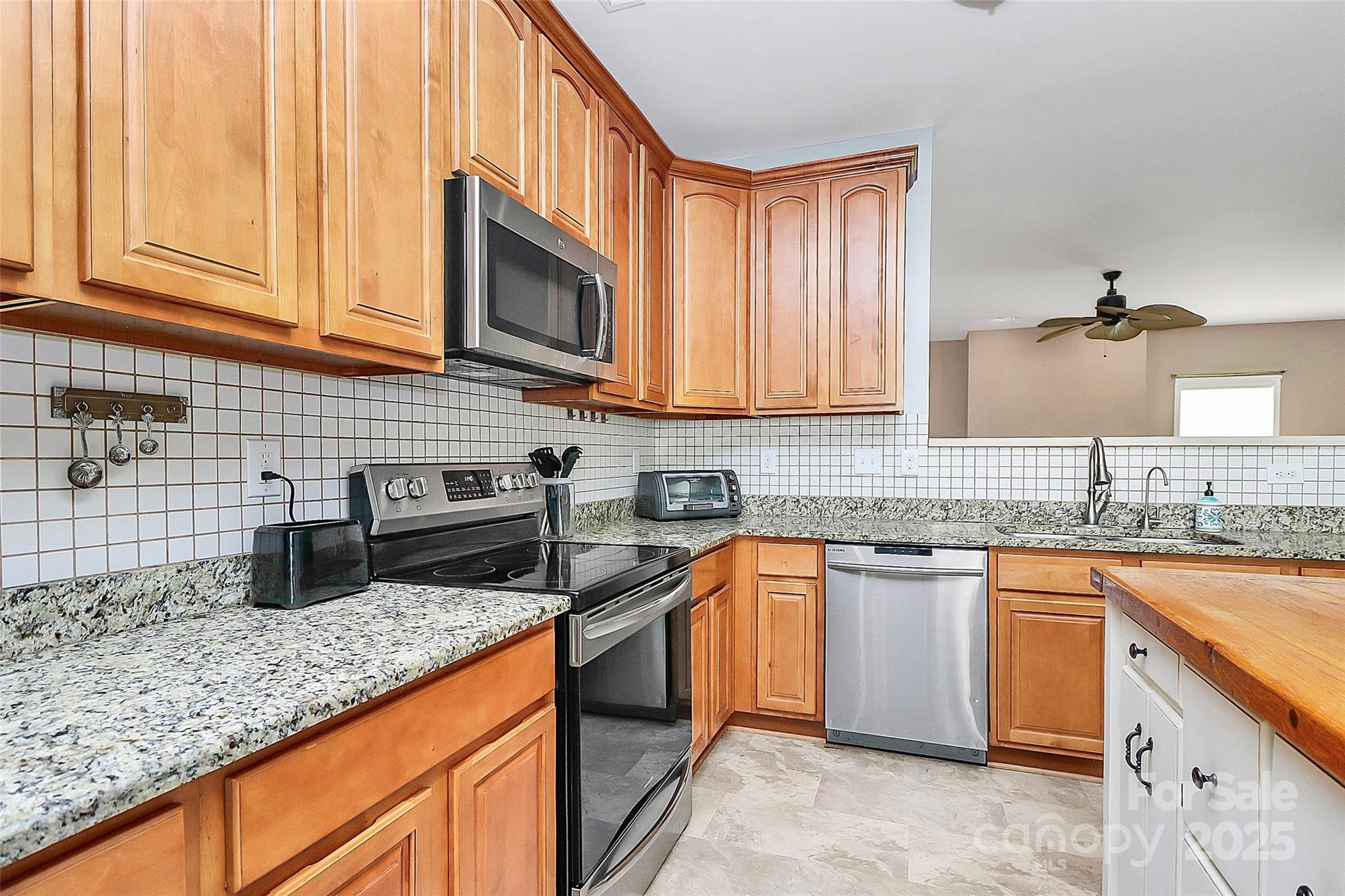 1817 Tradd Avenue Clover, SC 29710 - Photo 23 of 42 a kitchen with stainless steel appliances granite countertop a sink stove and cabinets