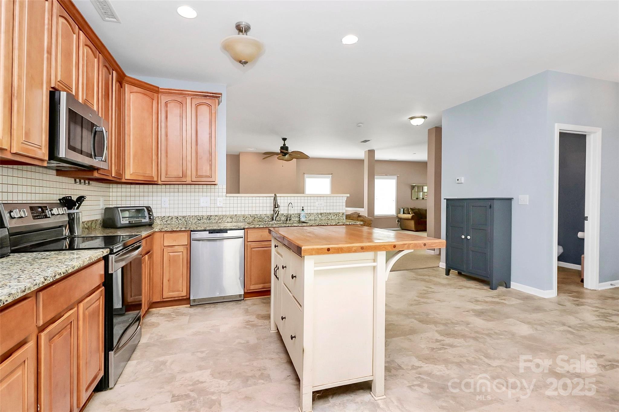 1817 Tradd Avenue Clover, SC 29710 - Photo 24 of 42 a kitchen with granite countertop a refrigerator stove top oven and sink