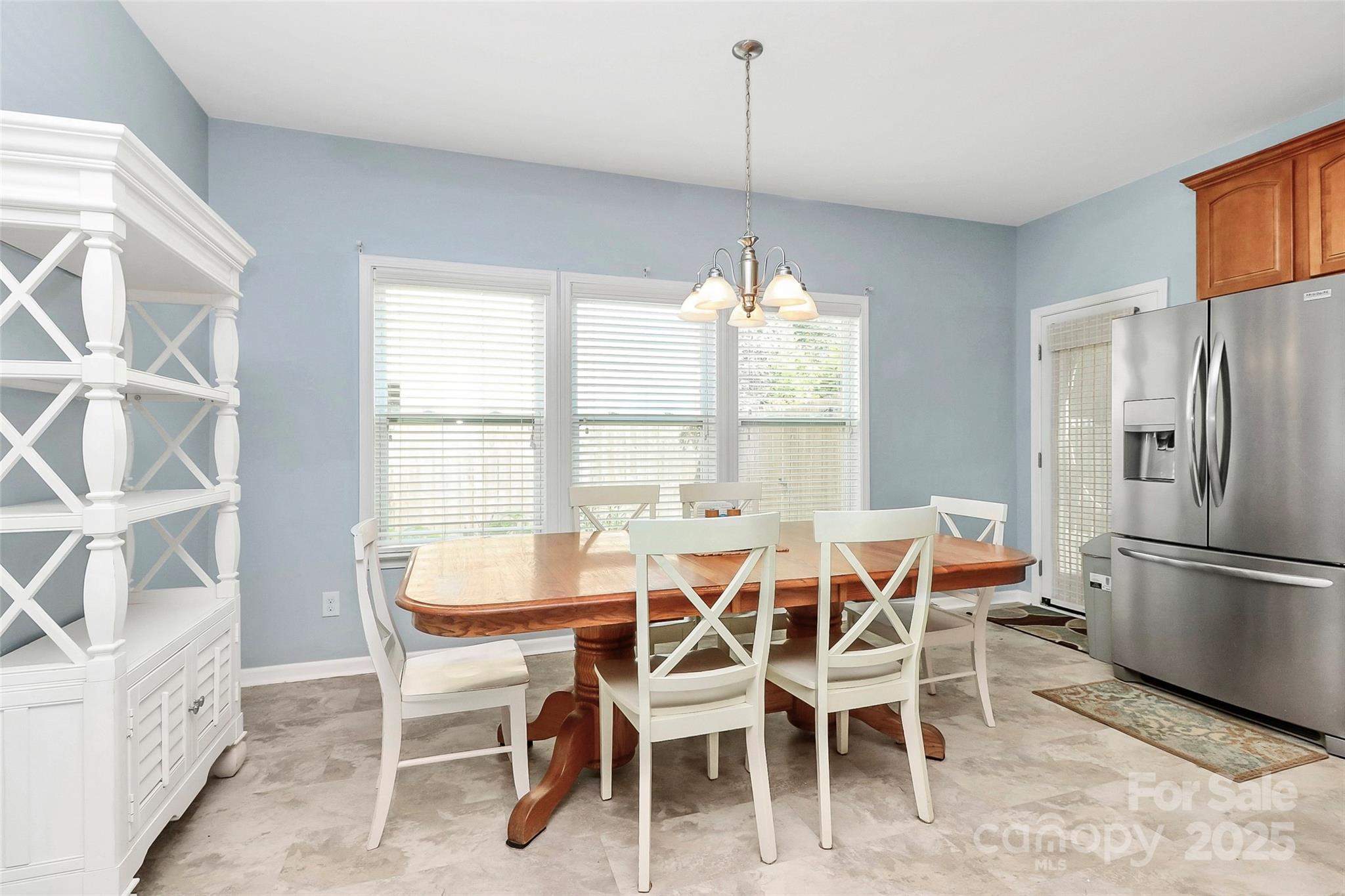1817 Tradd Avenue Clover, SC 29710 - Photo 26 of 42 a dining room with furniture a chandelier and kitchen view