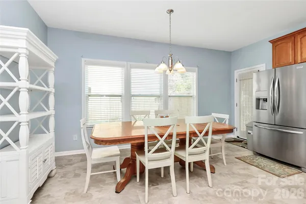 a store room with lots of clutter and white cabinets