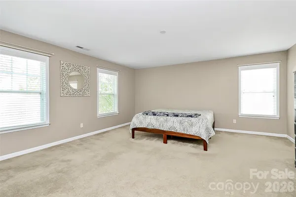 a room with a bed and a lamp