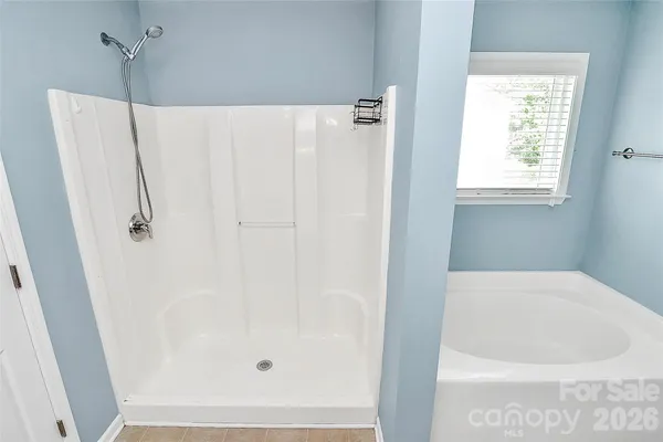 a white bath tub sitting next to a window