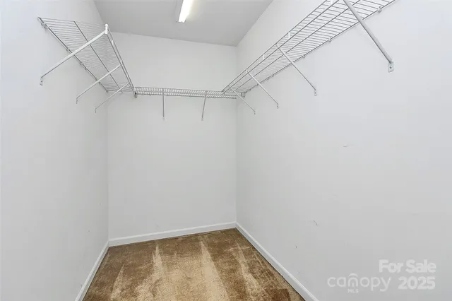 a bedroom with a bed and a dresser in it