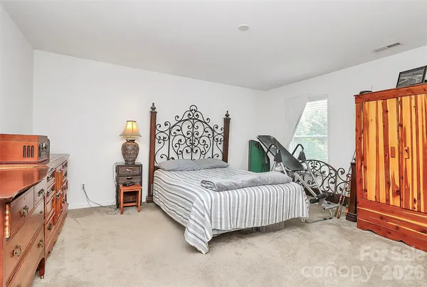 a bedroom with a bed and a dresser in it