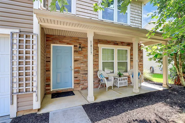 a view of a patio with table and chairs and potted plants