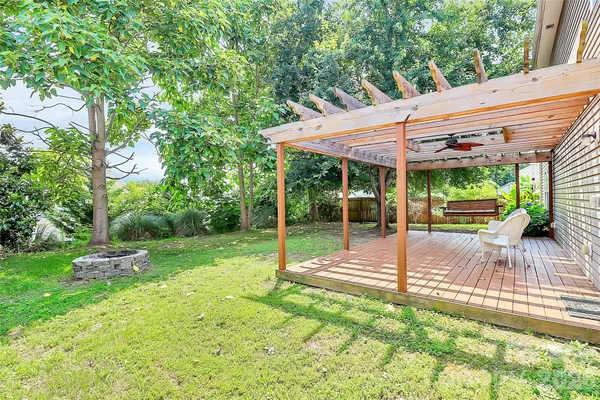 a view of a backyard with table and chairs under an umbrella