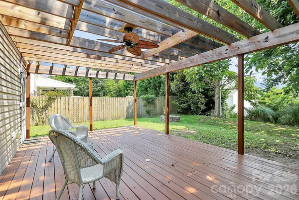 a view of a patio with a table chairs and a backyard