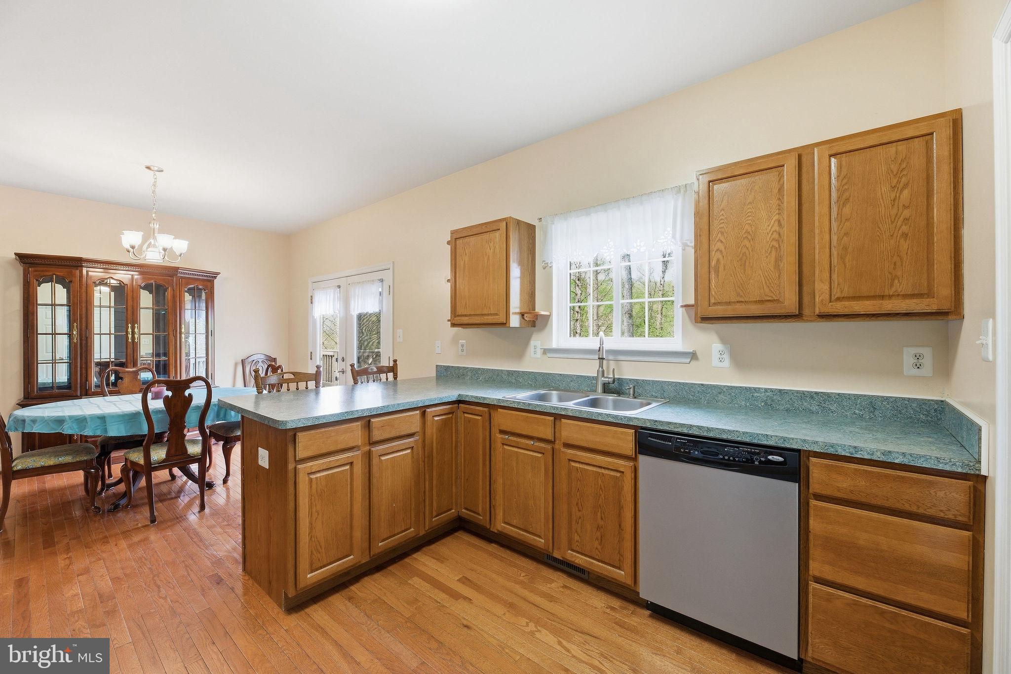 405 Ball Road St. Leonard, MD 20685 - Photo 14 of 40 a kitchen with lots of counter top space and dining table