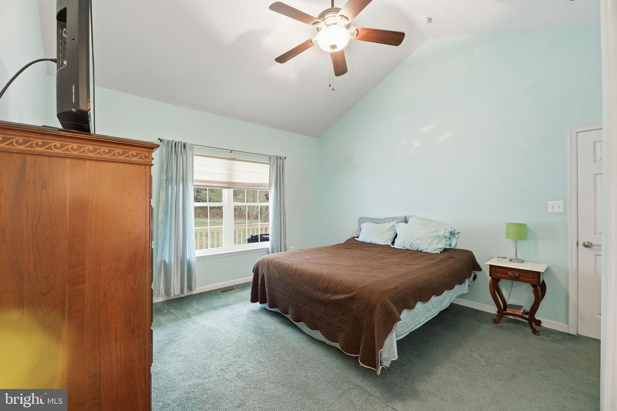405 Ball Road St. Leonard, MD 20685 - Photo 18 of 40 a spacious bedroom with a bed and window