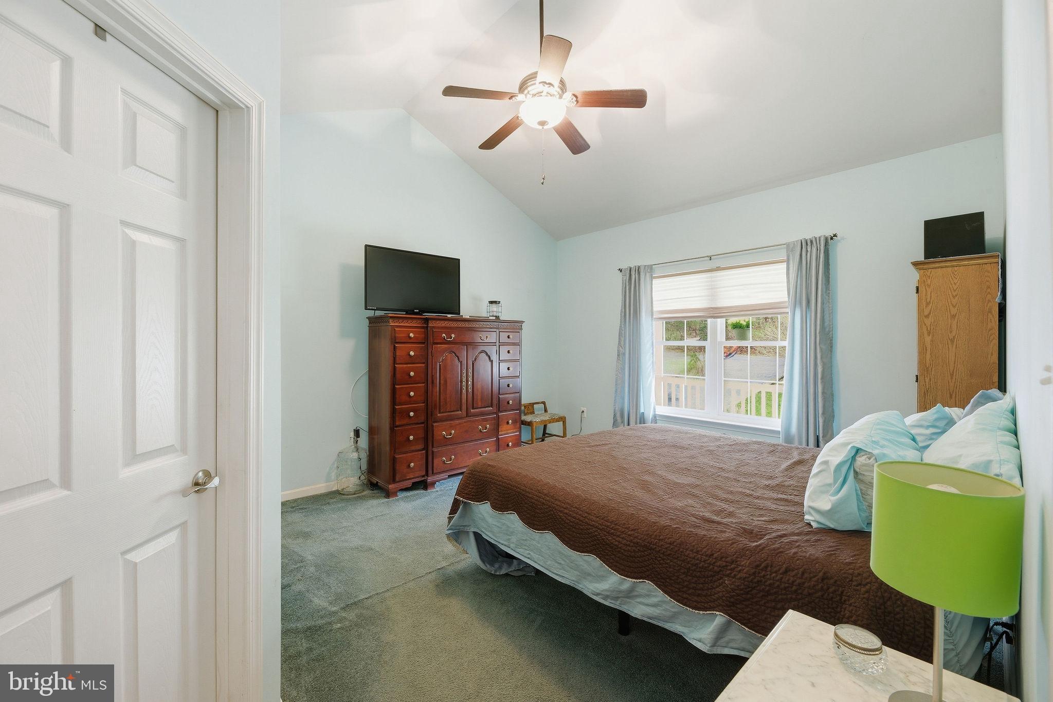 405 Ball Road St. Leonard, MD 20685 - Photo 19 of 40 a bedroom with a bed and a chandelier