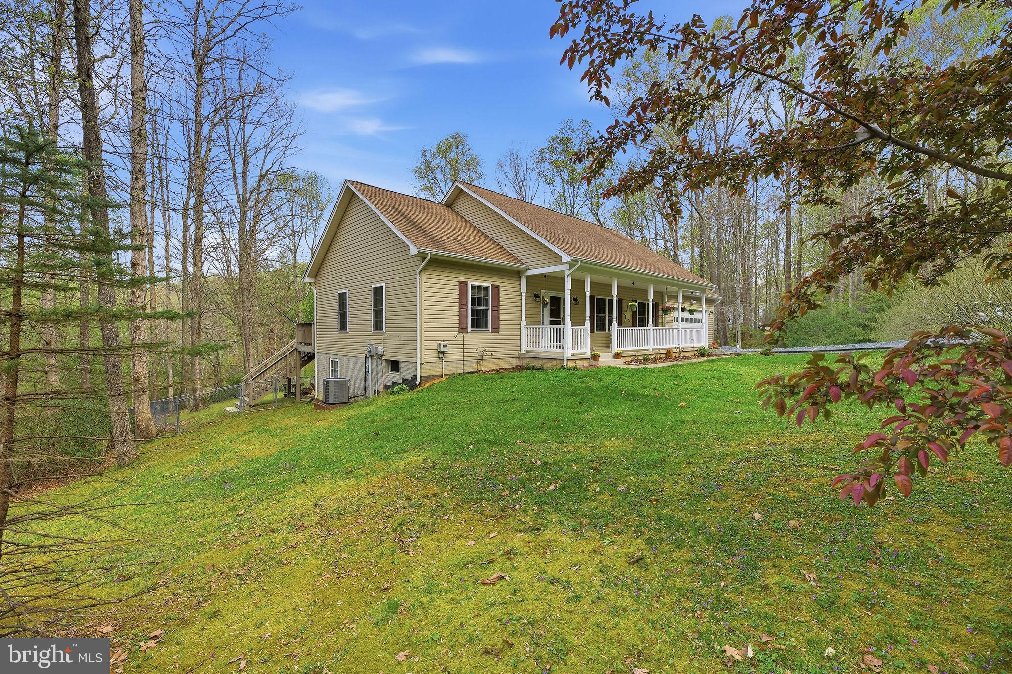 405 Ball Road St. Leonard, MD 20685 - Photo 30 of 40 a front view of a house with garden