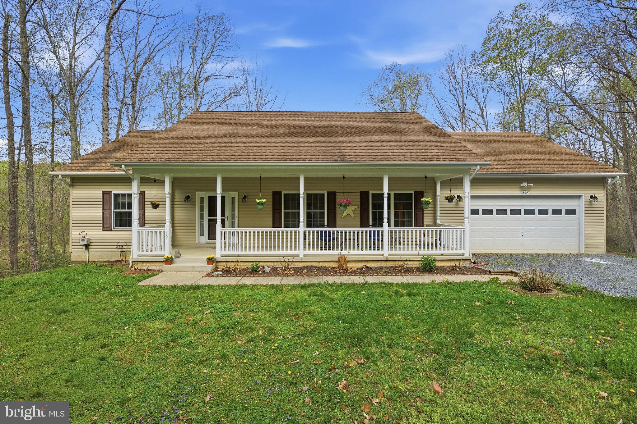 405 Ball Road St. Leonard, MD 20685 - Photo 5 of 40 a front view of a house with a yard and trees
