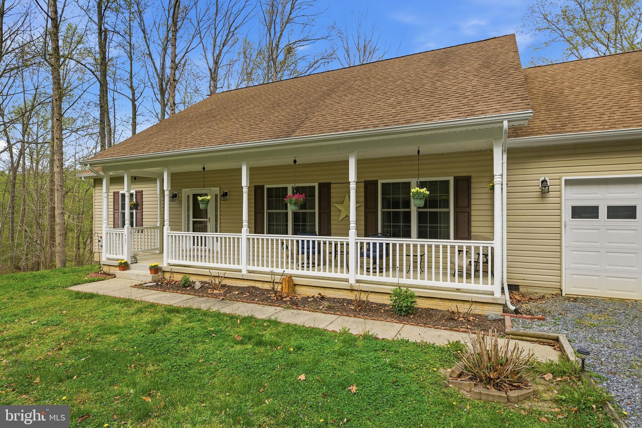 405 Ball Road St. Leonard, MD 20685 - Photo 6 of 40 a front view of a house with a yard