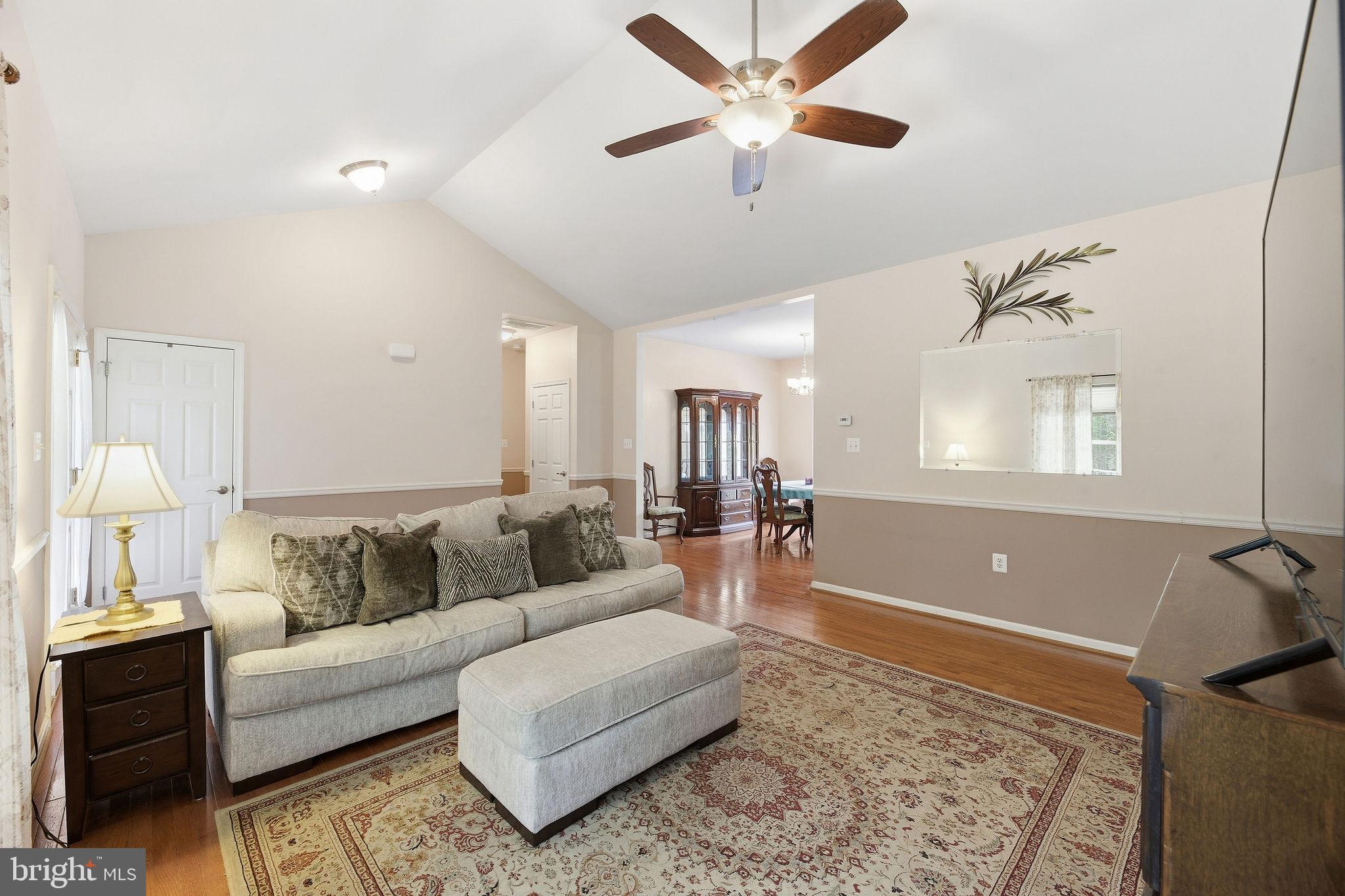 405 Ball Road St. Leonard, MD 20685 - Photo 9 of 40 a living room with furniture and a rug