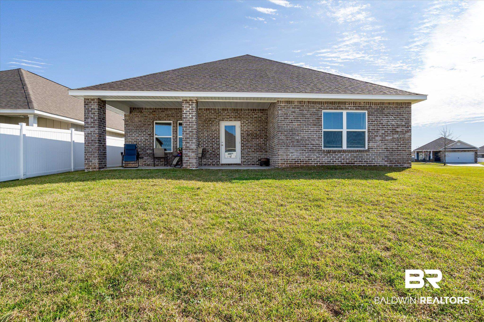 24262 Alydar Loop Daphne, AL 36526 - Photo 15 of 33 Back of property with a shingled roof, fence, a lawn, and brick siding