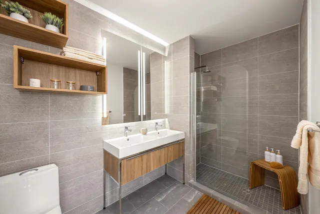 a bathroom with a sink a toilet and shower