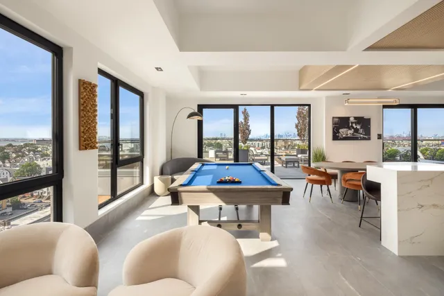 a living room with furniture a large window and kitchen view